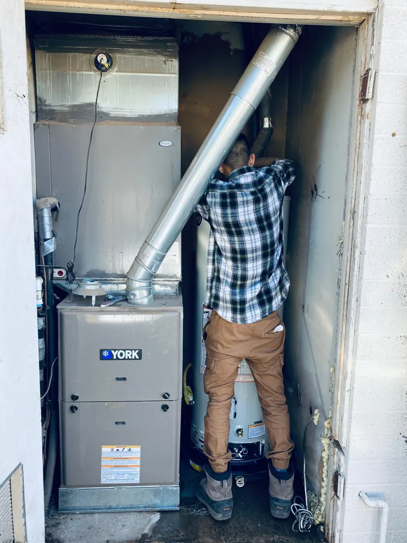 Technician working on a residential water heater