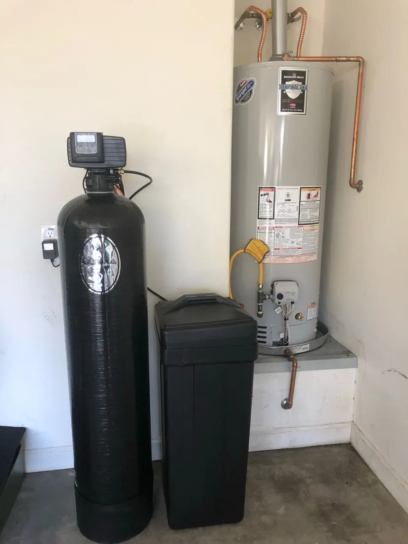 Installed water treatment equipment beside a water heater